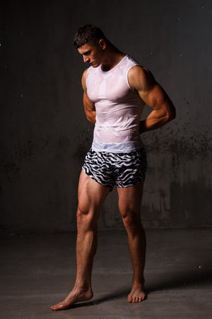 Athlete bodybuilder trains in the studio in the rain.の写真素材