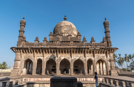 Vijaypura, India - February 15, 2019: Young girl looking at the dome of Ibrahim Roza tomb. Vijaypura, Karnataka, India.のeditorial素材