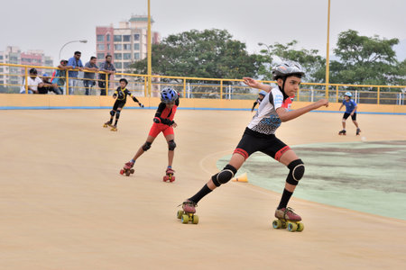 VIRAR, INDIA - OCTOBER 15, 2017: Kids are practising game of roller skating in the rink, some people...