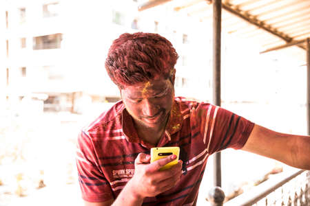 MUMBAI, MAHARASHTRA, INDIA- March 16: A young boy smiling after holi celebration, the Indian festival of colours, on March 16, 2016 in Virar, Mumbai, Maharashtra, India.のeditorial素材