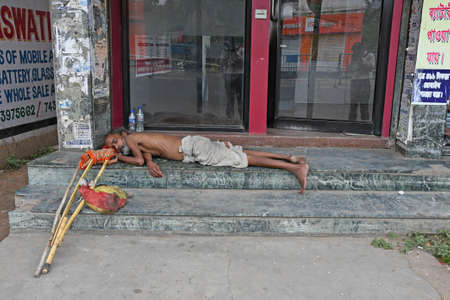 Burdwan Town, Purba Bardhaman District, West Bengal / India - 25.04.2020: People are sleeping in front of ATMs at the time of lockdown period due to Novel Coronavirus (COVID-19) emergence. At Burdwan Town, Purba Bardhaman District, West Bengal, India.のeditorial素材