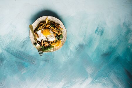 Healthy Breakfast with Wholemeal Bread Toast with Poached Egg, Avocado and Peas. Blue Canvas Background.の写真素材