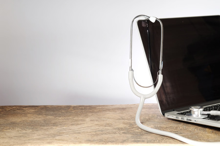 Medical stethoscope on a laptop computerの写真素材