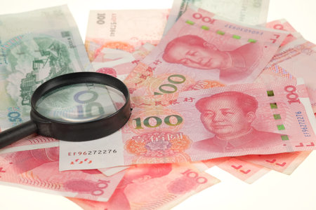 Chinese yuan, renminbi money and magnifying glassの写真素材