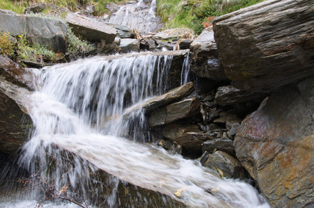 Stream cascading steeply over schist rock boulders, Matukituki Valley, Mount Aspiring National Park, New Zealandの写真素材
