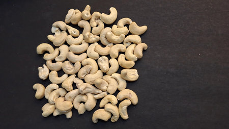 Cashew nuts on a black background, close-up shot.の写真素材