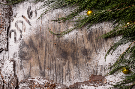 Christmas fir tree with decoration and snow on the dark wooden tableの写真素材