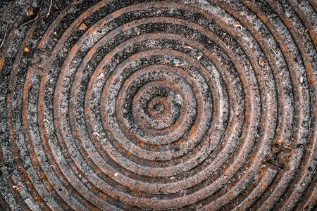 Manhole cover rusty. Old background vintage manhole in grunge style.の写真素材