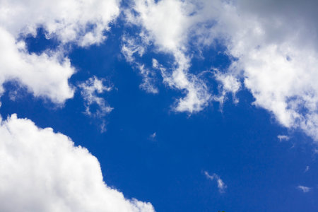 Beautiful white fluffy clouds in the blue sky daylight.