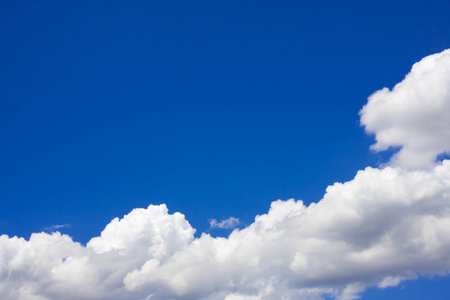 Beautiful white fluffy clouds in the blue sky daylight.