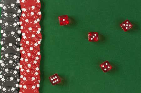 Gambling chips and dice  on the green backgroundの写真素材