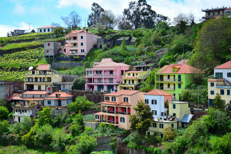 Colorful houses in green, pink, orange, blue and yellow. The small town Fontes at Madeira, Portugal. Image taken from public ground.の写真素材
