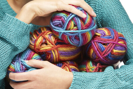 woman holding yarn rolls on a white backgroundの写真素材