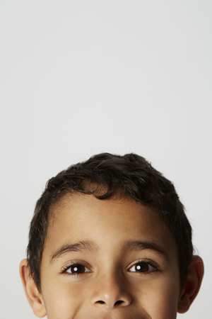 Boy peering at camera, high sectionの写真素材