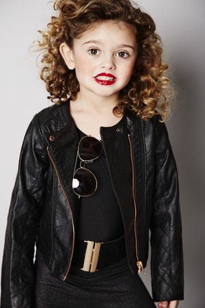 Smiling cool girl in leather jacket, portraitの写真素材