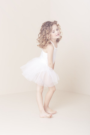 Young girl in ballet costume standing in studioの写真素材
