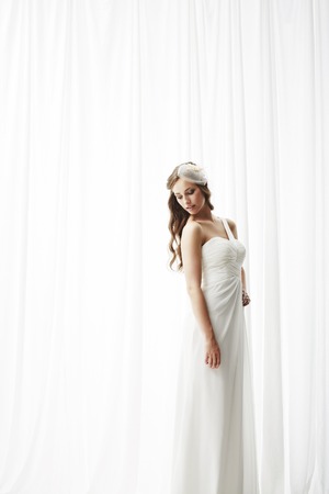 Young bride in wedding dress, studio shotの写真素材