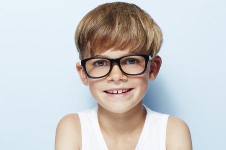 Portrait of young boy wearing glasses, studioの写真素材
