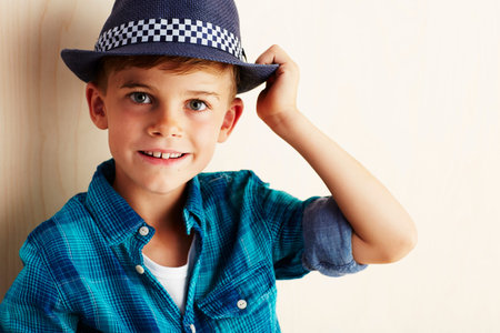 Portrait of young boy checked shirt and hat, smilingの写真素材