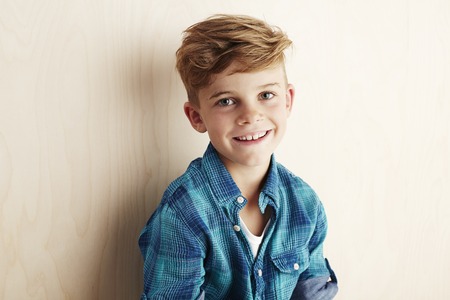 Portrait of young boy checked shirt, smilingの写真素材