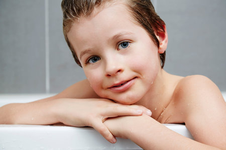 Young boy smiling in bath