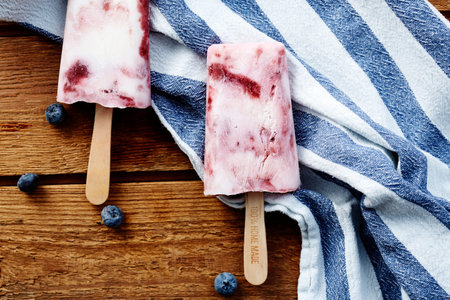 Blueberry smoothie ice lollies in studio