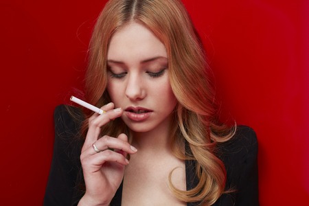 Beautiful young woman with cigaretteの写真素材