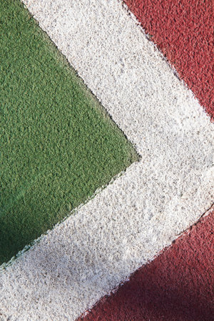 Close up of green and red tennis court markings