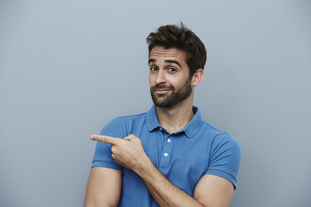 Dude pointing off camera, portraitの写真素材