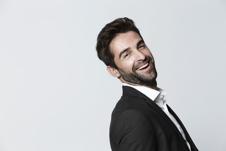 Carefree man in suit, laughingの写真素材