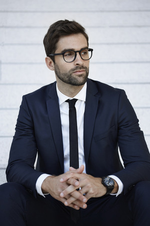 Businessman in blue suit looking awayの写真素材