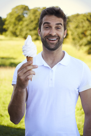 Portrait of man with ice cream, smilingの写真素材