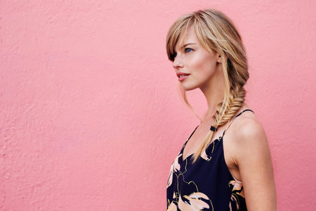 Gorgeous blond woman against pink backgroundの写真素材