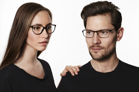 Cool couple wearing glasses in studioの写真素材