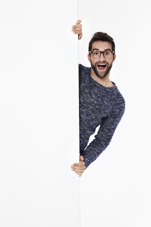 Surprised guy in white studio, portraitの写真素材