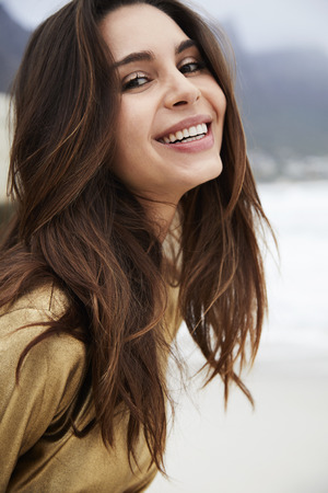 Beautiful brunette woman smiling at cameraの写真素材