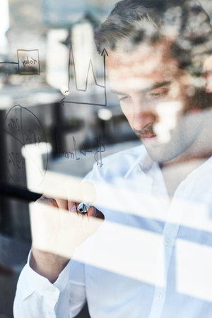 Businessman writing on glass, close up