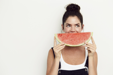 Watermelon smile on young woman, looking awayの写真素材