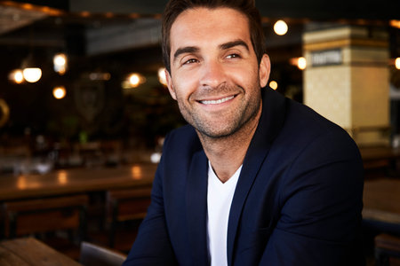 Dude in jacket smiling and looking awayの写真素材