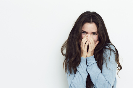 Giggling girl in studio, portraitの写真素材