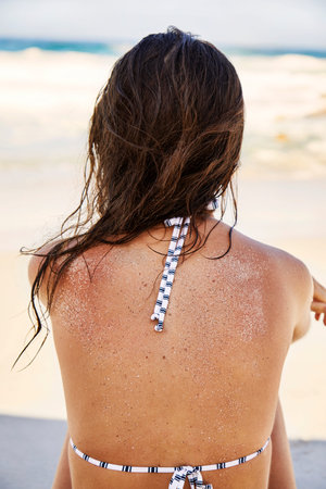 Beach girl looking out to sea