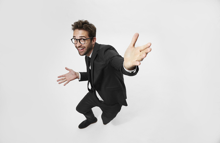 Carefree businessman in white studioの写真素材