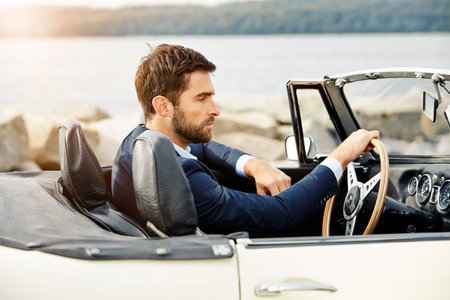 Dude in sports car wearing suitの写真素材