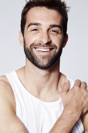 Stubble man smiling at camera, close upの写真素材