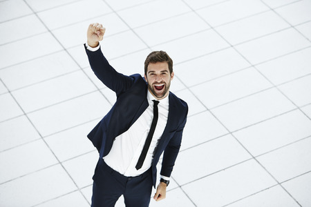 Business dude punching air in suit, portraitの写真素材