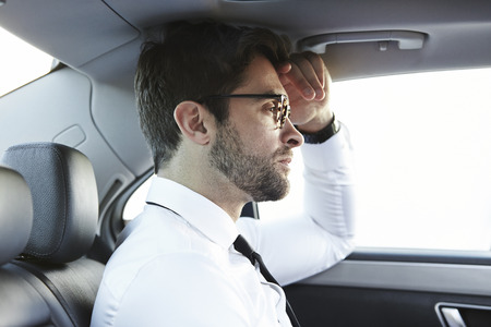 White shirt guy in car, looking awayの写真素材