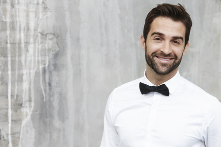 Bow tie dude smiling in white shirt, portraitの写真素材
