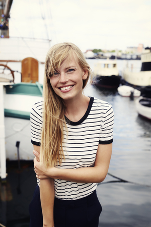 Stunning blond woman smiling at cameraの写真素材