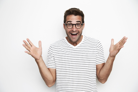Ecstatic guy in glasses and t-shirt, portraitの写真素材