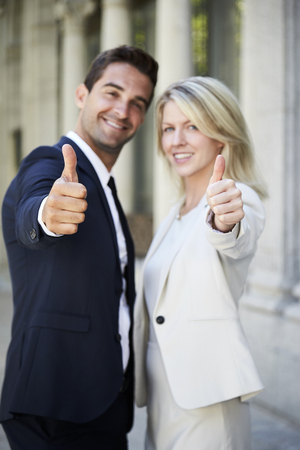 Thumbs up from business colleagues, portraitの写真素材